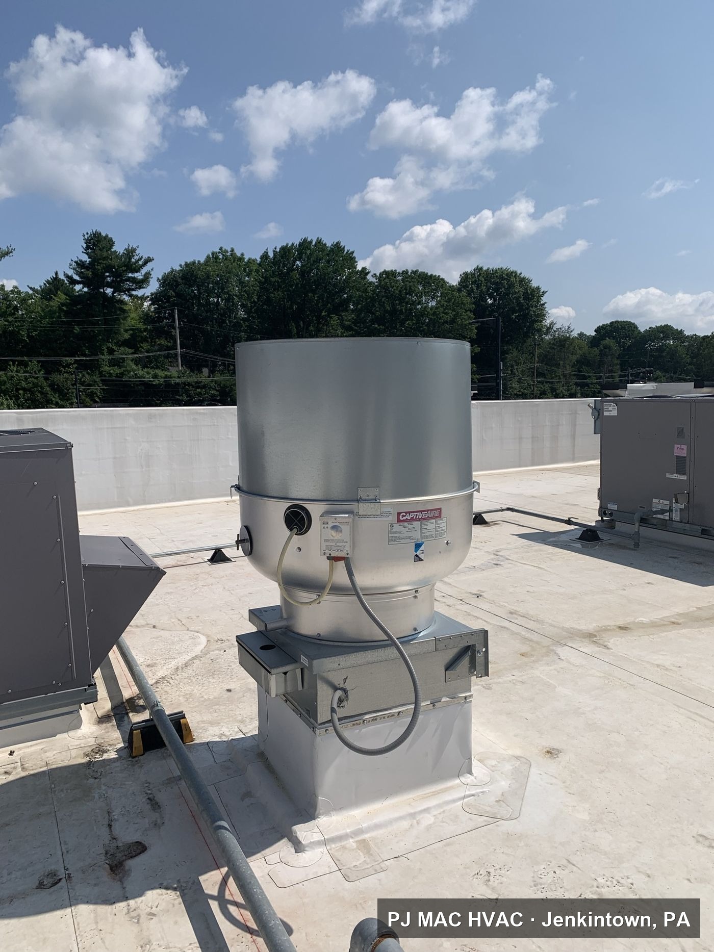 A new CaptiveAire kitchen exhaust fan installed by PJ MAC HVAC on a commercial roof.