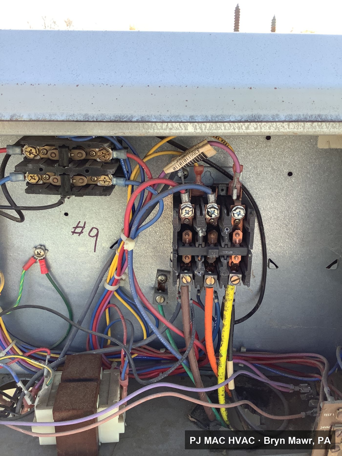 PJ MAC HVAC troubleshoots the contactor and control wiring inside an HVAC unit electrical compartment.