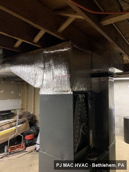 Insulated supply ductwork fabricated by PJ MAC HVAC above a basement air handler.